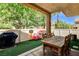 Artificial grass backyard with covered patio, outdoor grill and dining table for entertaining at 67 Dow Jones St # 2, Henderson, NV 89074