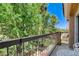 Balcony overlooking green backyard area with seating for relaxing and enjoying the outdoors at 67 Dow Jones St # 2, Henderson, NV 89074