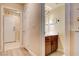This is a powder room with a wood vanity, tile flooring, and a decorative sign on the wall at 67 Dow Jones St # 2, Henderson, NV 89074