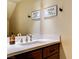 Close up shot of a bathroom sink with modern faucet, white countertop, and dark wood vanity at 67 Dow Jones St # 2, Henderson, NV 89074