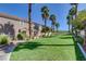 Expansive green common area with mature trees and palm trees offering a tranquil environment at 67 Dow Jones St # 2, Henderson, NV 89074
