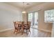 Bright dining area features wood floors, table with four chairs, and sliding door to the backyard at 67 Dow Jones St # 2, Henderson, NV 89074