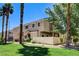 Exterior view of home with well-manicured lawn and mature landscaping with palm trees at 67 Dow Jones St # 2, Henderson, NV 89074
