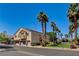 Spacious townhome featuring an attached garage, private balcony, and mature palm trees at 67 Dow Jones St # 2, Henderson, NV 89074