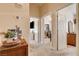 Hallway with wood floors leading to bedrooms and a decorative wood table with plant at 67 Dow Jones St # 2, Henderson, NV 89074