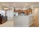 Inviting open kitchen with stainless steel appliances, decor, wood cabinets, and breakfast bar with tile floors at 67 Dow Jones St # 2, Henderson, NV 89074