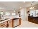 Bright open kitchen features stainless steel appliances and breakfast bar with hardwood flooring and natural light at 67 Dow Jones St # 2, Henderson, NV 89074