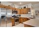 Well-equipped kitchen with stainless steel appliances, wood cabinets, and ample counter space with decor at 67 Dow Jones St # 2, Henderson, NV 89074