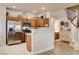 Spacious kitchen with stainless steel appliances, wood cabinets, breakfast bar open to stairs and adjacent bathroom at 67 Dow Jones St # 2, Henderson, NV 89074