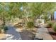 Well-maintained landscaping with gravel, trees, and pathways surrounding the homes in the community at 67 Dow Jones St # 2, Henderson, NV 89074