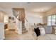 Cozy living room next to stairway, with wood-look flooring and access to dining area at 67 Dow Jones St # 2, Henderson, NV 89074