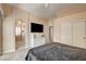 This is a main bedroom with a sitting area, a television, and an en-suite bathroom at 67 Dow Jones St # 2, Henderson, NV 89074