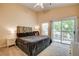 Bright main bedroom with sliding glass door leading to private balcony overlooking the neighborhood at 67 Dow Jones St # 2, Henderson, NV 89074