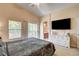 Spacious main bedroom with en-suite bathroom, large windows and a television at 67 Dow Jones St # 2, Henderson, NV 89074