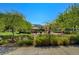 A fun and safe playground area surrounded by lush trees and greenery for children to enjoy at 67 Dow Jones St # 2, Henderson, NV 89074