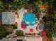 Aerial view of a backyard oasis with a large pool, spa, tiki bar, and lush landscaping at 7001 Via Locanda Ave, Las Vegas, NV 89131