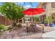 Backyard with a dining table and an umbrella, perfect for enjoying outdoor meals and sunny days at 7001 Via Locanda Ave, Las Vegas, NV 89131