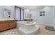 Luxurious bathroom featuring a large soaking tub, elegant fixtures, and contemporary design at 7001 Via Locanda Ave, Las Vegas, NV 89131