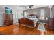 Elegant main bedroom showcasing hardwood floors, a large decorative bed frame, and sophisticated furnishings at 7001 Via Locanda Ave, Las Vegas, NV 89131