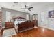 Beautiful main bedroom showcases wood floors, elegant furnishings, and an ensuite bath entrance at 7001 Via Locanda Ave, Las Vegas, NV 89131