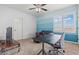 This bedroom is painted with blue stripes and features a ceiling fan and carpeted floors at 7001 Via Locanda Ave, Las Vegas, NV 89131