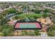 Aerial view of a community park with a tennis court, playground, and green space at 7001 Via Locanda Ave, Las Vegas, NV 89131