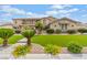 Attractive home featuring a well-manicured lawn, a three-car garage, and a spacious driveway at 7001 Via Locanda Ave, Las Vegas, NV 89131