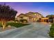 Spacious home with a three-car garage, extended driveway, and manicured front yard at 7001 Via Locanda Ave, Las Vegas, NV 89131