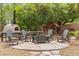 Outdoor firepit area with Adirondack chairs, a brick oven, and wood storage at 7001 Via Locanda Ave, Las Vegas, NV 89131