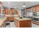 Spacious kitchen featuring a large island, stainless steel appliances, and custom cabinetry at 7001 Via Locanda Ave, Las Vegas, NV 89131