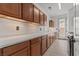 Laundry room with ample cabinet space and a sink for convenient household tasks at 7001 Via Locanda Ave, Las Vegas, NV 89131
