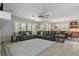 Open-concept living space with plush seating, ample natural light, and dining area at 7001 Via Locanda Ave, Las Vegas, NV 89131