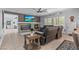 Open living space features a stone fireplace, built-in shelving, and comfortable reclining furniture at 7001 Via Locanda Ave, Las Vegas, NV 89131