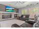 Comfortable living room boasts a stone fireplace, built-in shelving, and a plush sectional sofa at 7001 Via Locanda Ave, Las Vegas, NV 89131