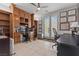 Home office with built-in shelves, tile flooring, and French doors providing plenty of light at 7001 Via Locanda Ave, Las Vegas, NV 89131