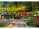 Outdoor entertainment space featuring a stone fireplace, seating, and ambient lighting at 7001 Via Locanda Ave, Las Vegas, NV 89131