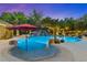 Resort-style pool area with a waterfall, grotto, and lush landscaping, ideal for entertaining at 7001 Via Locanda Ave, Las Vegas, NV 89131