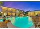 Backyard pool with rock features and landscaping, perfect for outdoor living and relaxation at 7001 Via Locanda Ave, Las Vegas, NV 89131