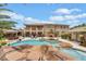 Resort-style pool with a rock waterfall, tiki bar, and lush tropical landscaping at 7001 Via Locanda Ave, Las Vegas, NV 89131