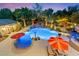 Overhead view of a backyard oasis with a large pool, waterfall features, and lounge chairs at 7001 Via Locanda Ave, Las Vegas, NV 89131