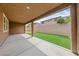 Covered patio with concrete flooring overlooks the low maintenance backyard with artificial grass at 705 Coastal Lagoon St, Henderson, NV 89002