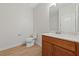 Bright bathroom with white walls, wood-look floors, and a single sink vanity at 705 Coastal Lagoon St, Henderson, NV 89002