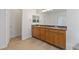Bathroom featuring double sinks, a large mirror, and wooden cabinets at 705 Coastal Lagoon St, Henderson, NV 89002