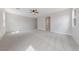 Bright bedroom featuring neutral paint, ceiling fan, and plush carpet flooring at 705 Coastal Lagoon St, Henderson, NV 89002
