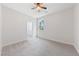Bedroom showcasing a walk-in closet, ceiling fan, and a large window at 705 Coastal Lagoon St, Henderson, NV 89002