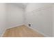 Empty walk-in closet featuring white walls, white shelving, and wood-look floors at 705 Coastal Lagoon St, Henderson, NV 89002
