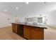 Open kitchen with a large island featuring dark granite countertops and stainless steel sink at 705 Coastal Lagoon St, Henderson, NV 89002