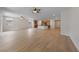 Open-concept living space showcasing light wood floors, large windows, and a kitchen with an island at 705 Coastal Lagoon St, Henderson, NV 89002