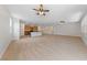 Open-concept living space showcasing light wood floors, large windows, and a kitchen with an island at 705 Coastal Lagoon St, Henderson, NV 89002