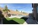 Serene backyard with pool, outdoor kitchen, lush turf, and privacy wall at 754 Agate Hills St, Las Vegas, NV 89138